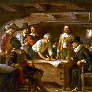 A group of Pilgrims gathers aboard the Mayflower to sign the compact. The image represents one of the earliest forms of American democratic agreement, highlighting the importance of compromise in politics in establishing a governance framework.