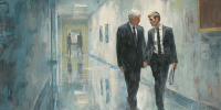 Two lawyers walk down a hallway.