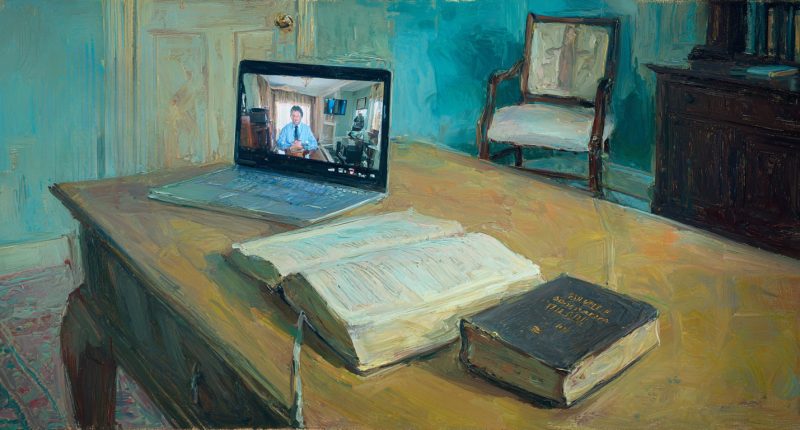 A tidy study with a closed Bible on a desk beside an open laptop showing a podcaster on a video feed, the chair slightly pulled back as if someone just stood up.