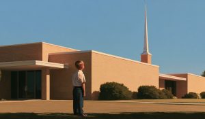 A child looks up at a sunlit chapel spire, showing how church steeples direct attention toward heaven.