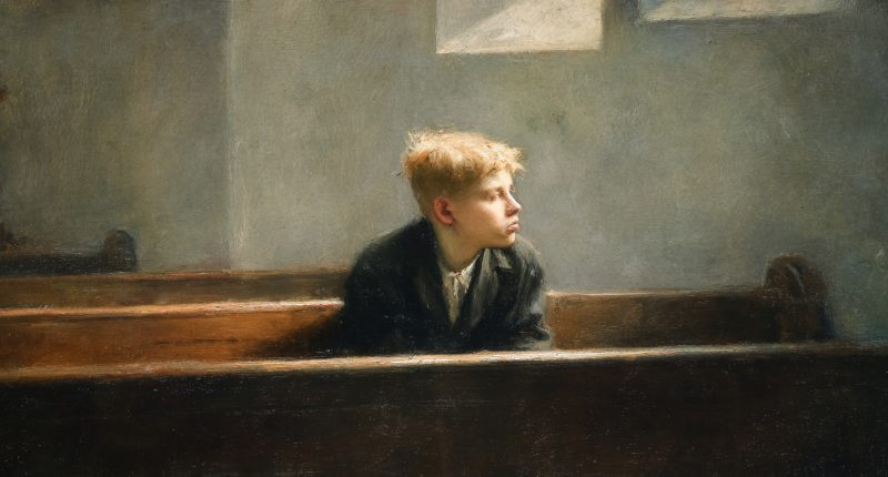 A teenage boy sits alone in a chapel, reflecting the loneliness and faith of unanswered prayers.