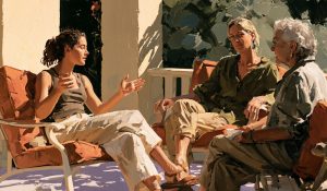Three generations share a conversation, illustrating women’s agency and the wisdom to choose well.