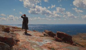  A man stands alone on a rocky coast looking out at the sea. Hope in hard times as deliverance appears small but real.