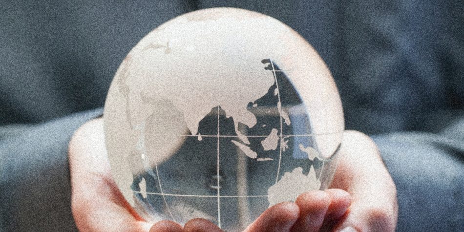 Hands Holding Glass Globe with Blue in the Background | Zero Population Growth Isn’t the Answer | Public Square Magazine | Zero Population Growth Movement