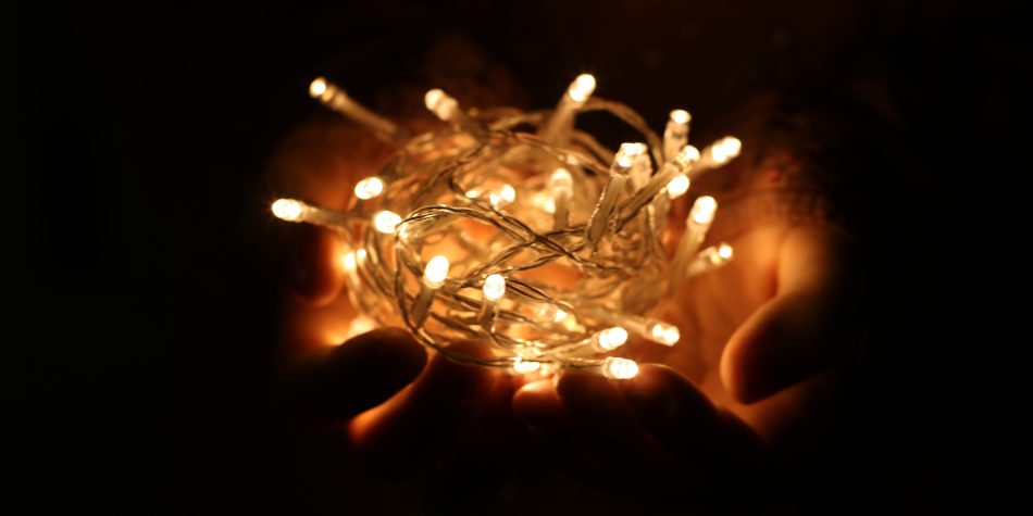 person-showing-white-string-lights-during-nightime-754203
