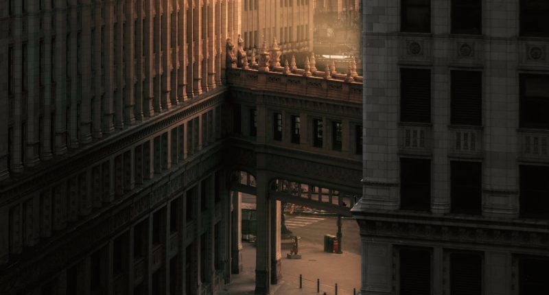 Bridge Between Tall Buildings Connecter Over A City Street, Sunlit | LDS Response to $100 Billion Scandal | LDS Charitable Fund