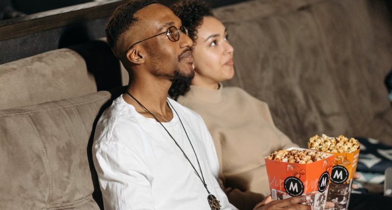 Couple with Popcorn Watching a Movie Together | Are Mature Adult Movies Really Just Crass? | Public Square Magazine | What Does For Mature Audiences Only Really Mean?