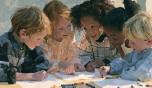 Elementary students smile while working on an art project.