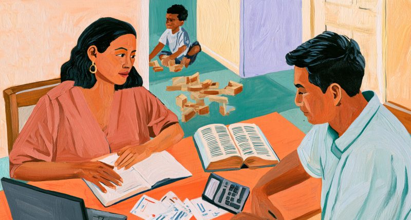 Parents discuss tithing and their family budget while a child plays nearby.