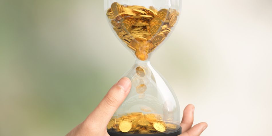 Hourglass with coins, symbolic of the slipping economic conditions leading to poverty increase.